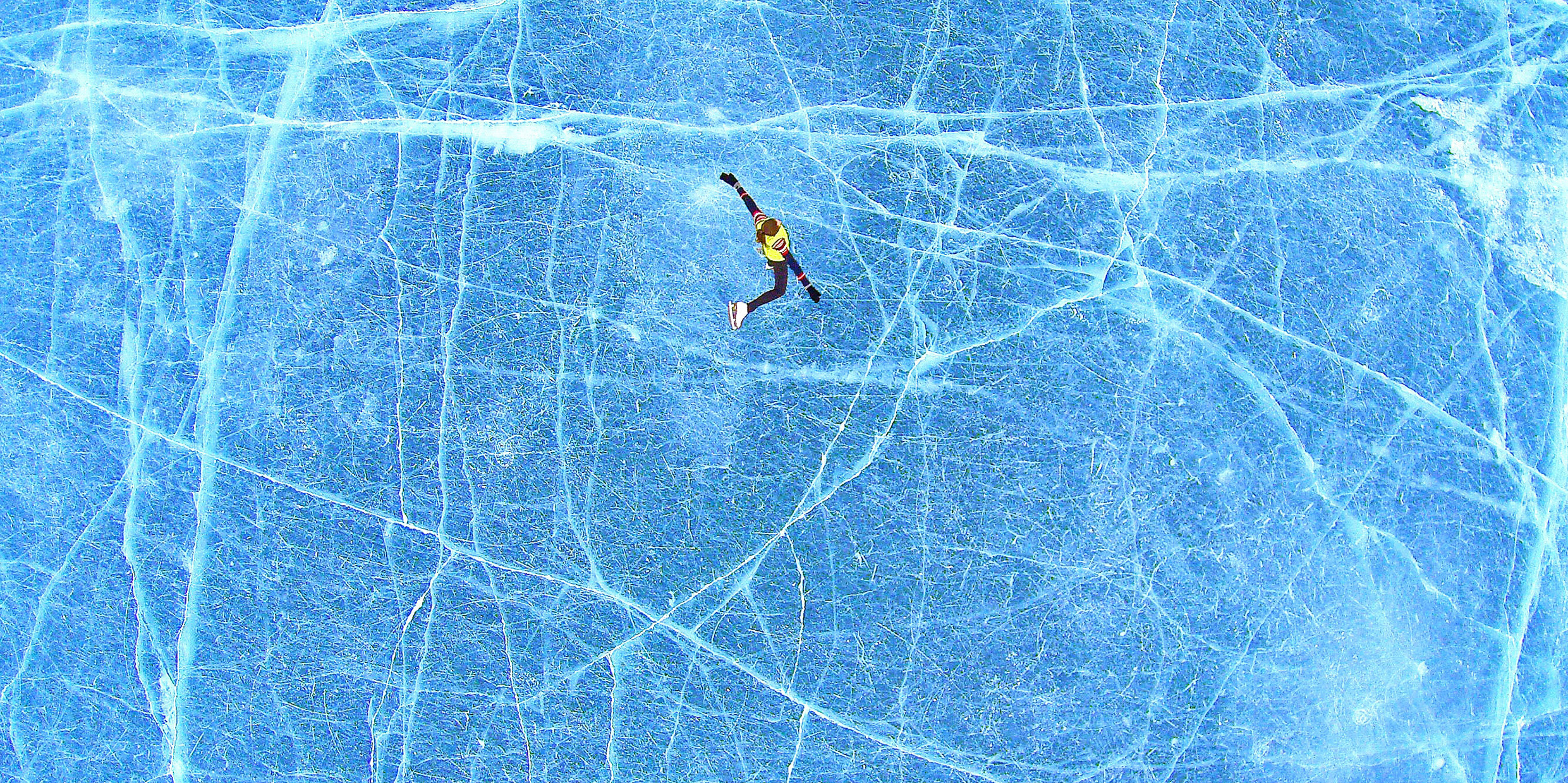 Image of ice skater on frozen pond