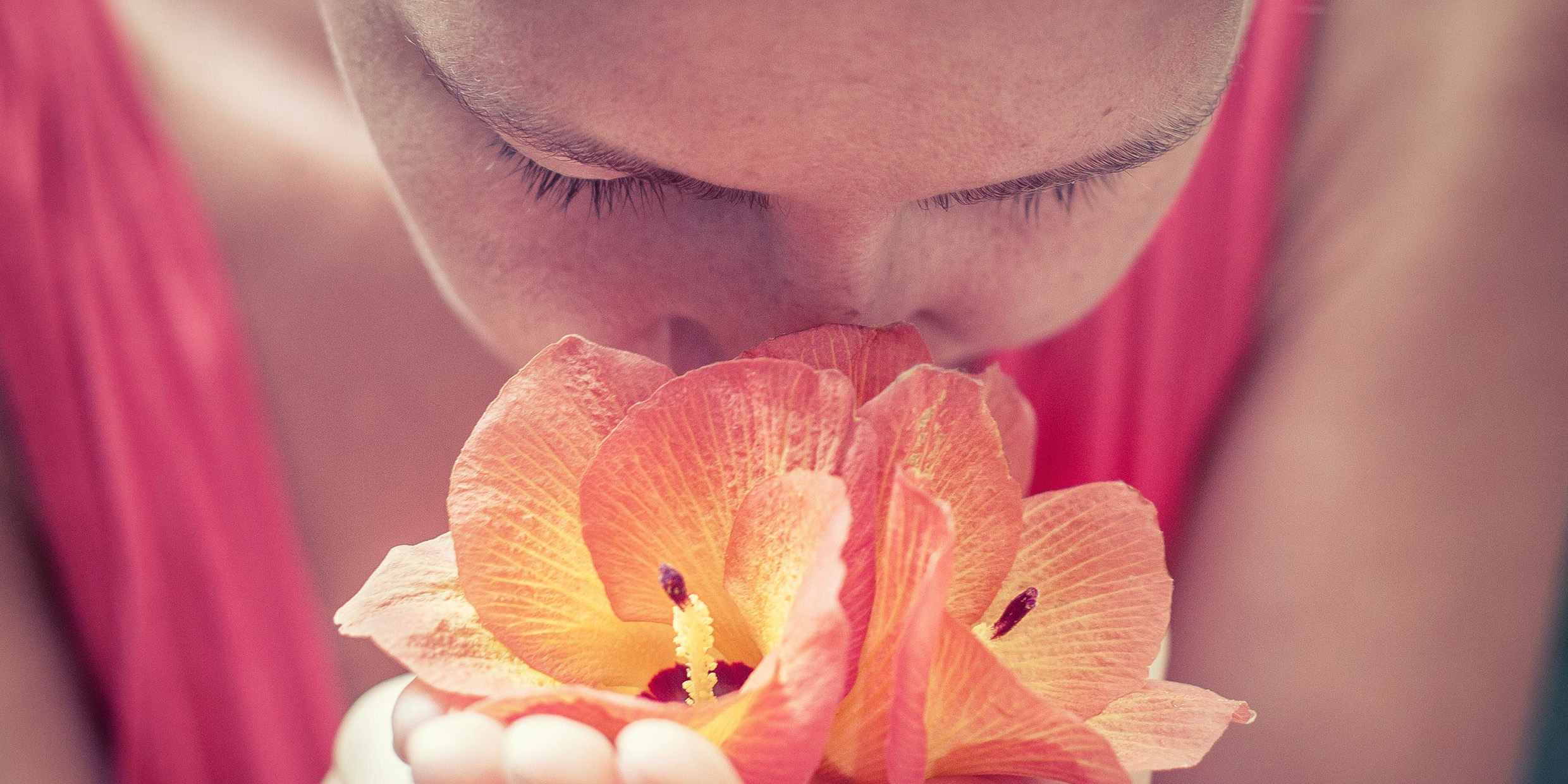 Image of woman smelling flower