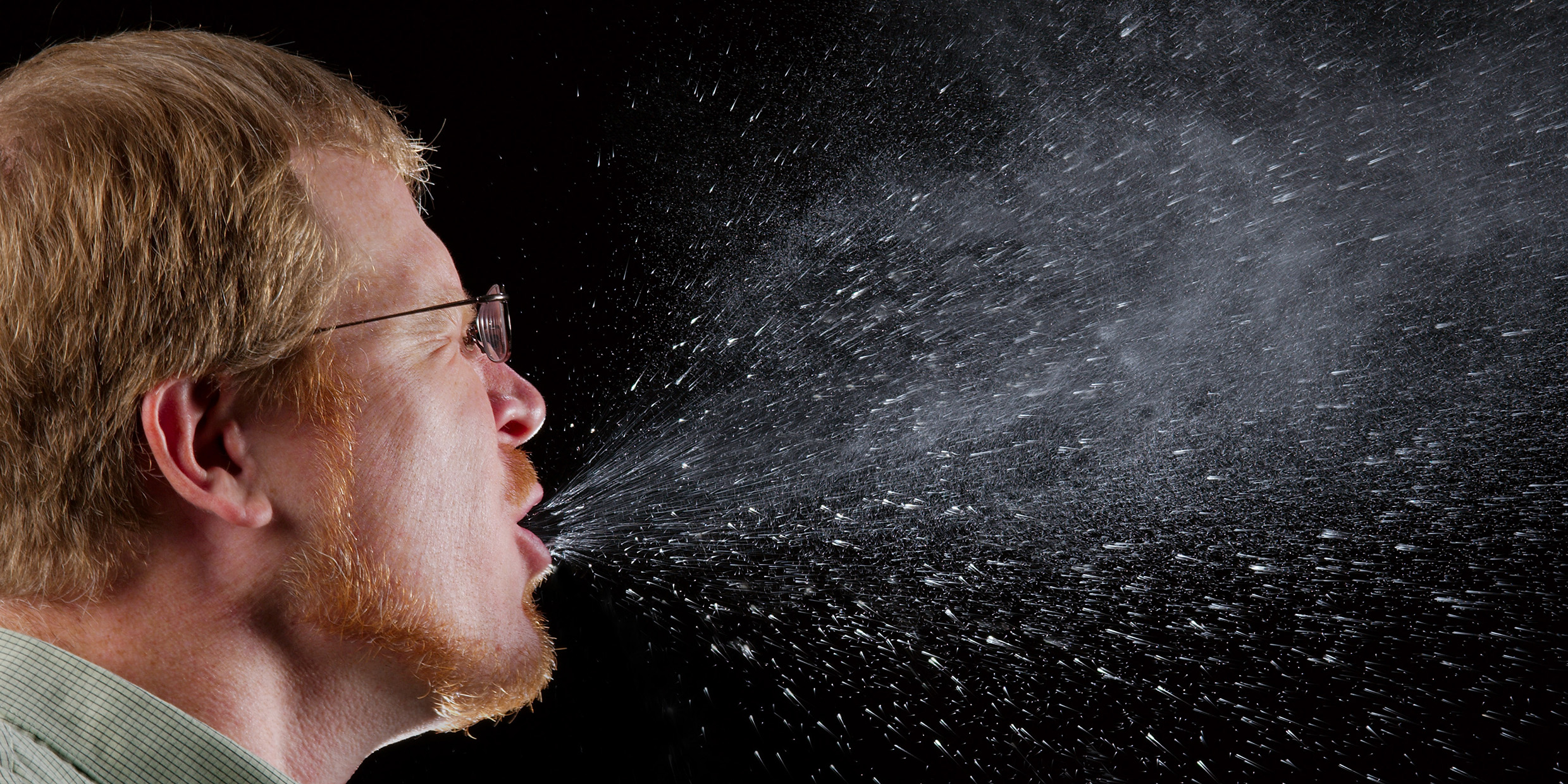 Image of man sneezing