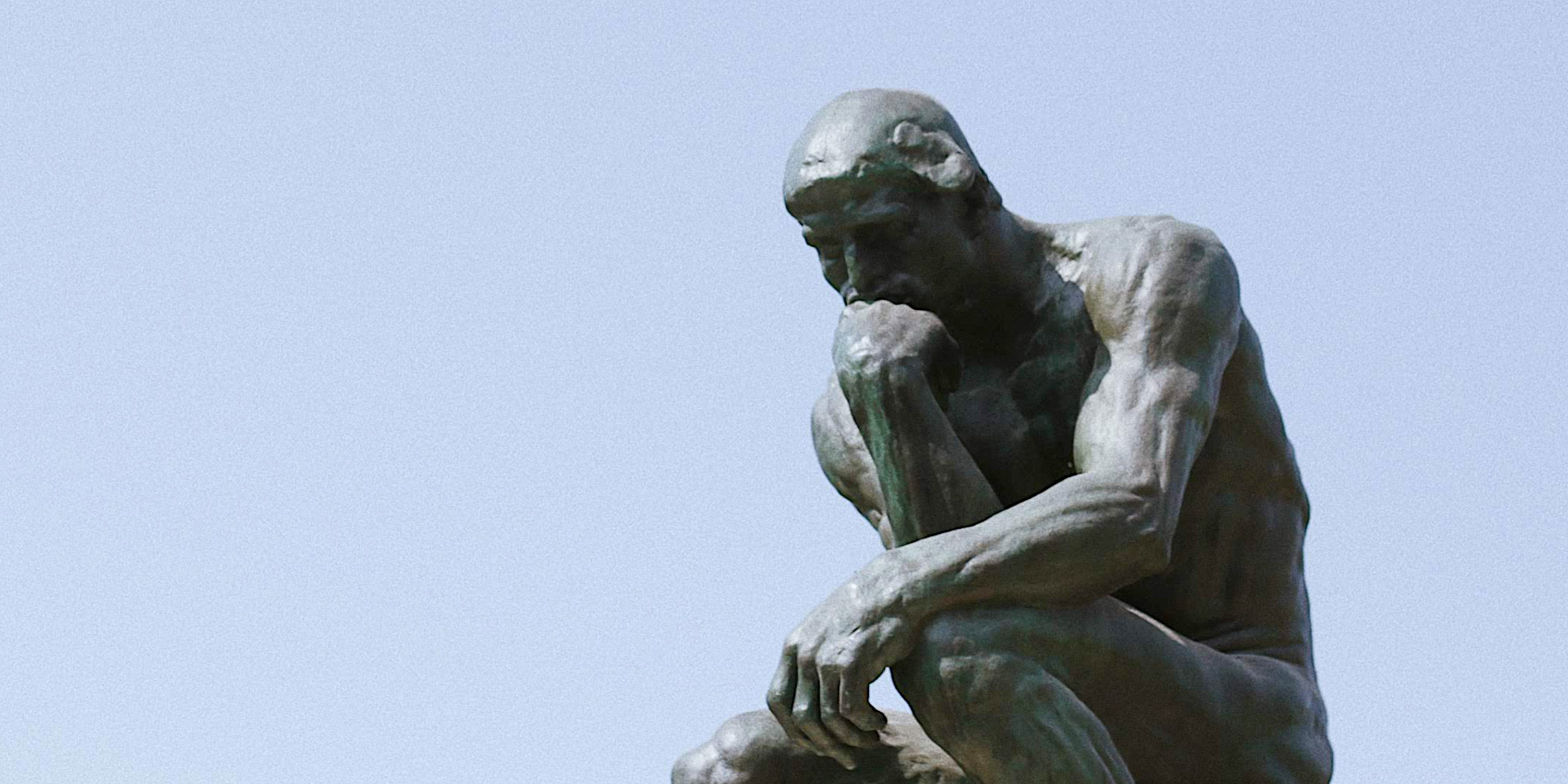 Sculpture of man in thought by Rodin