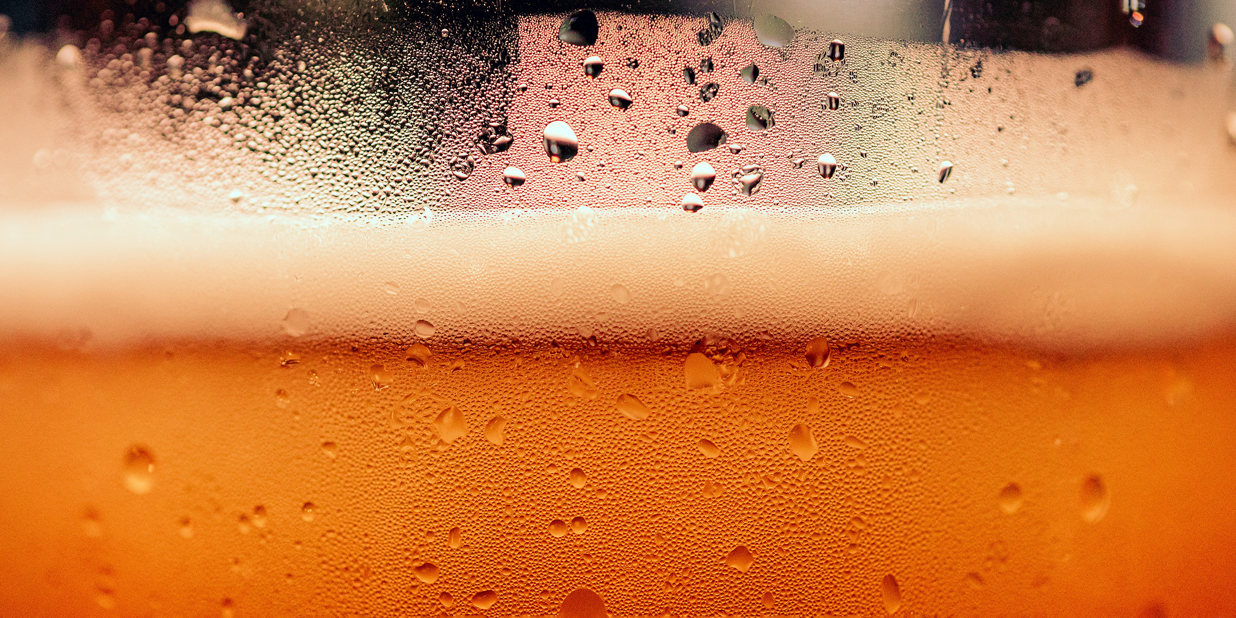 Close up image of beer bubbles in glass