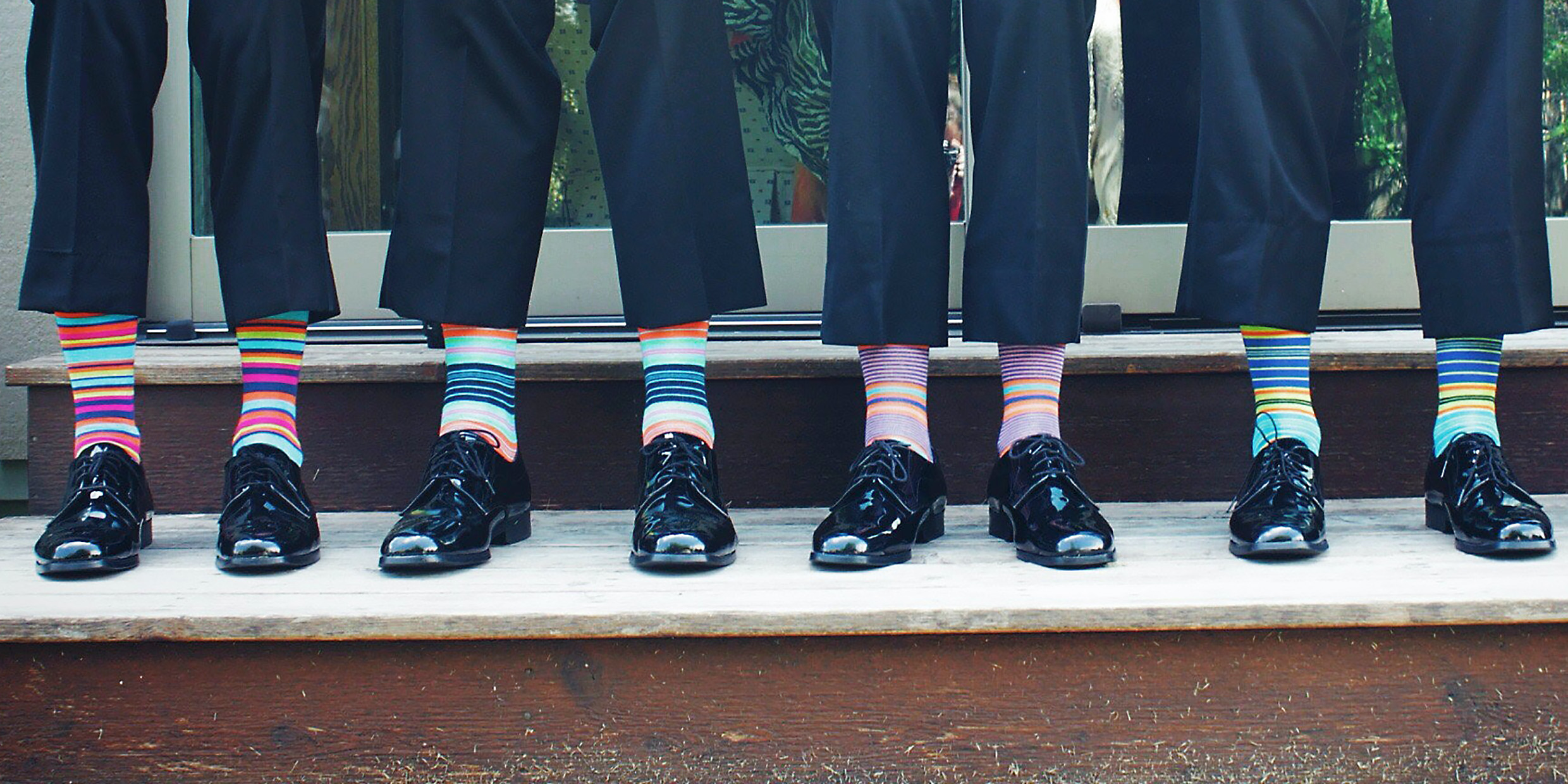 Image of four men with colorful matched socks
