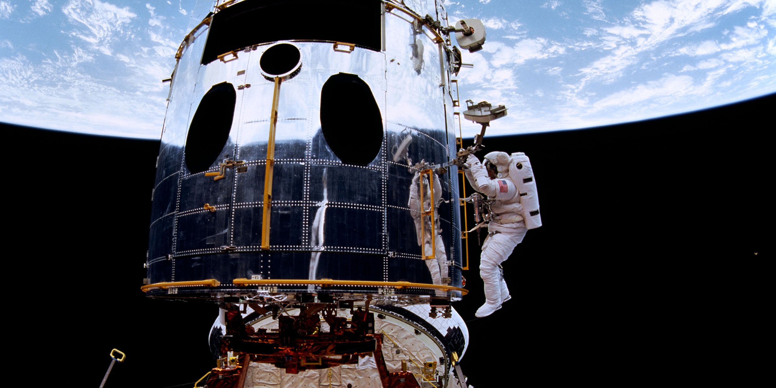 Image of astronaut repairing Hubble telescope in orbit