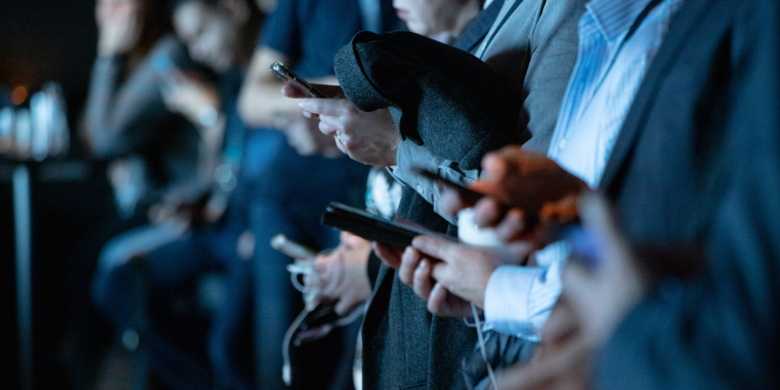 Image of a group of people interacting with their mobile devices