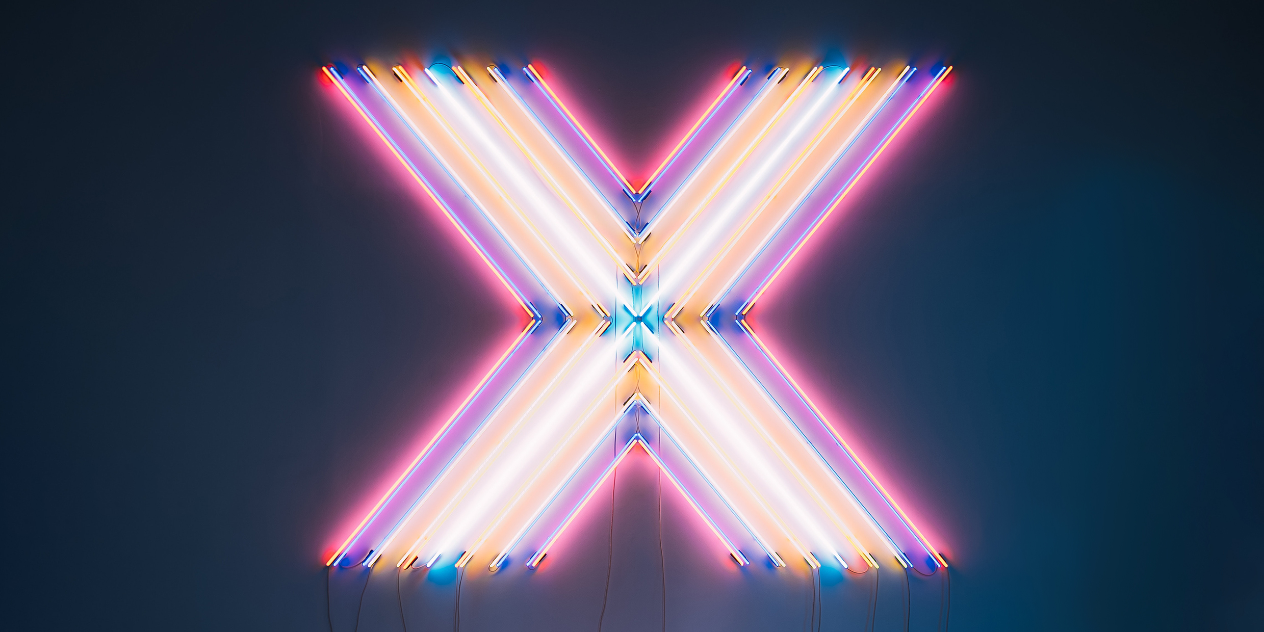 Image of large letter X made from neon lights