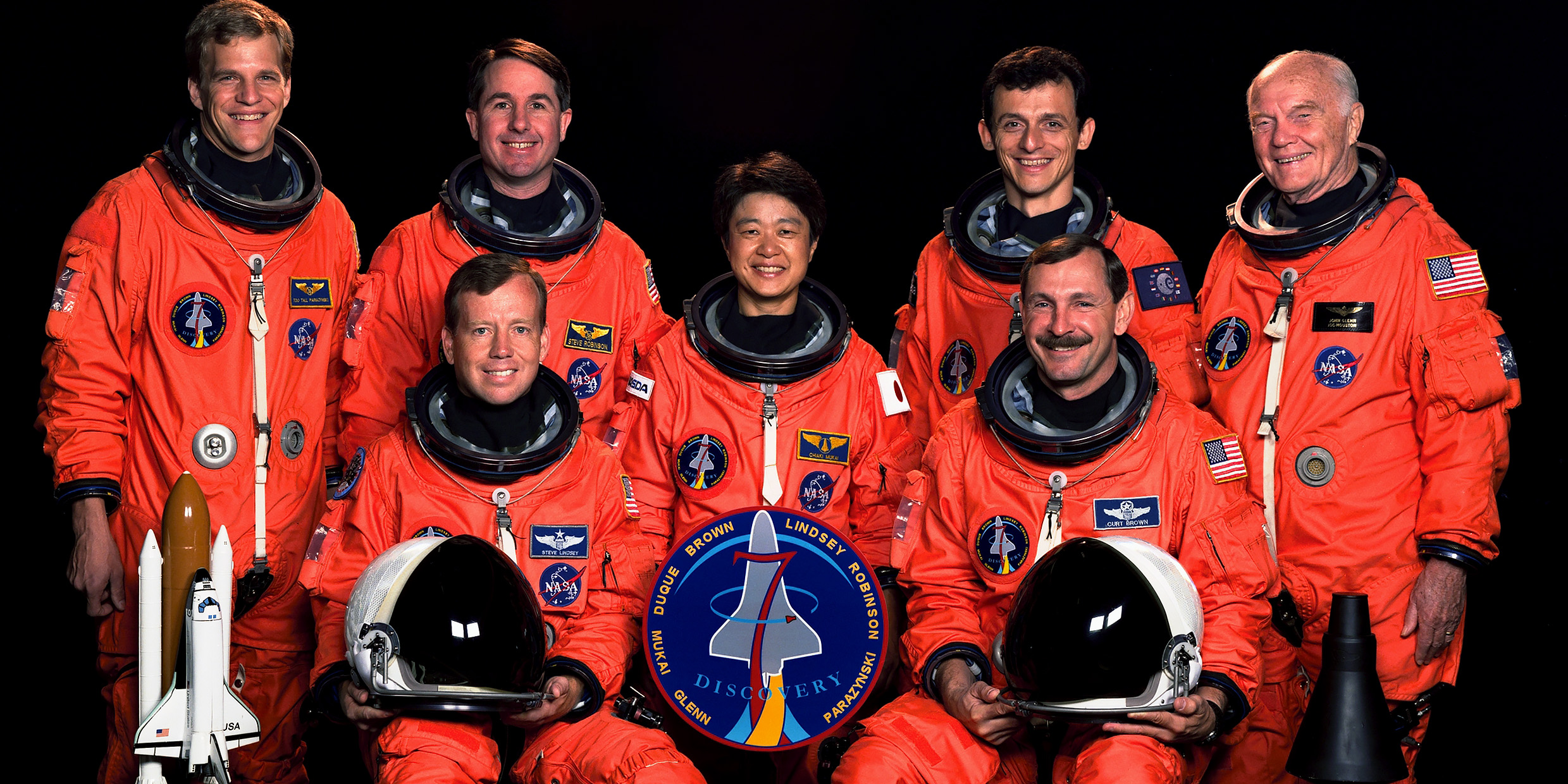 Group photo of NASA astronauts, including an elderly John Glenn