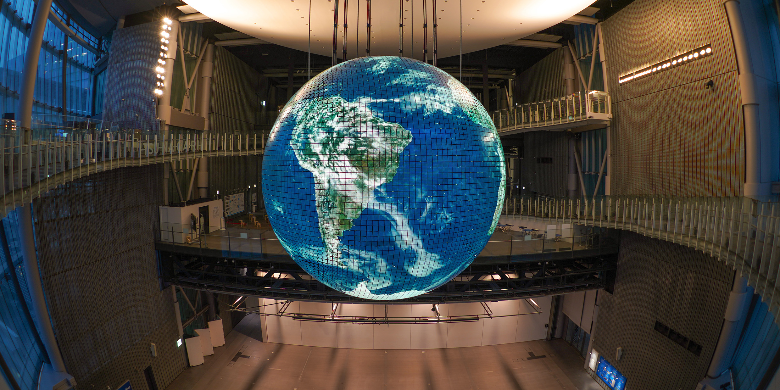 Image of a large model of the Earth hanging inside an atrium