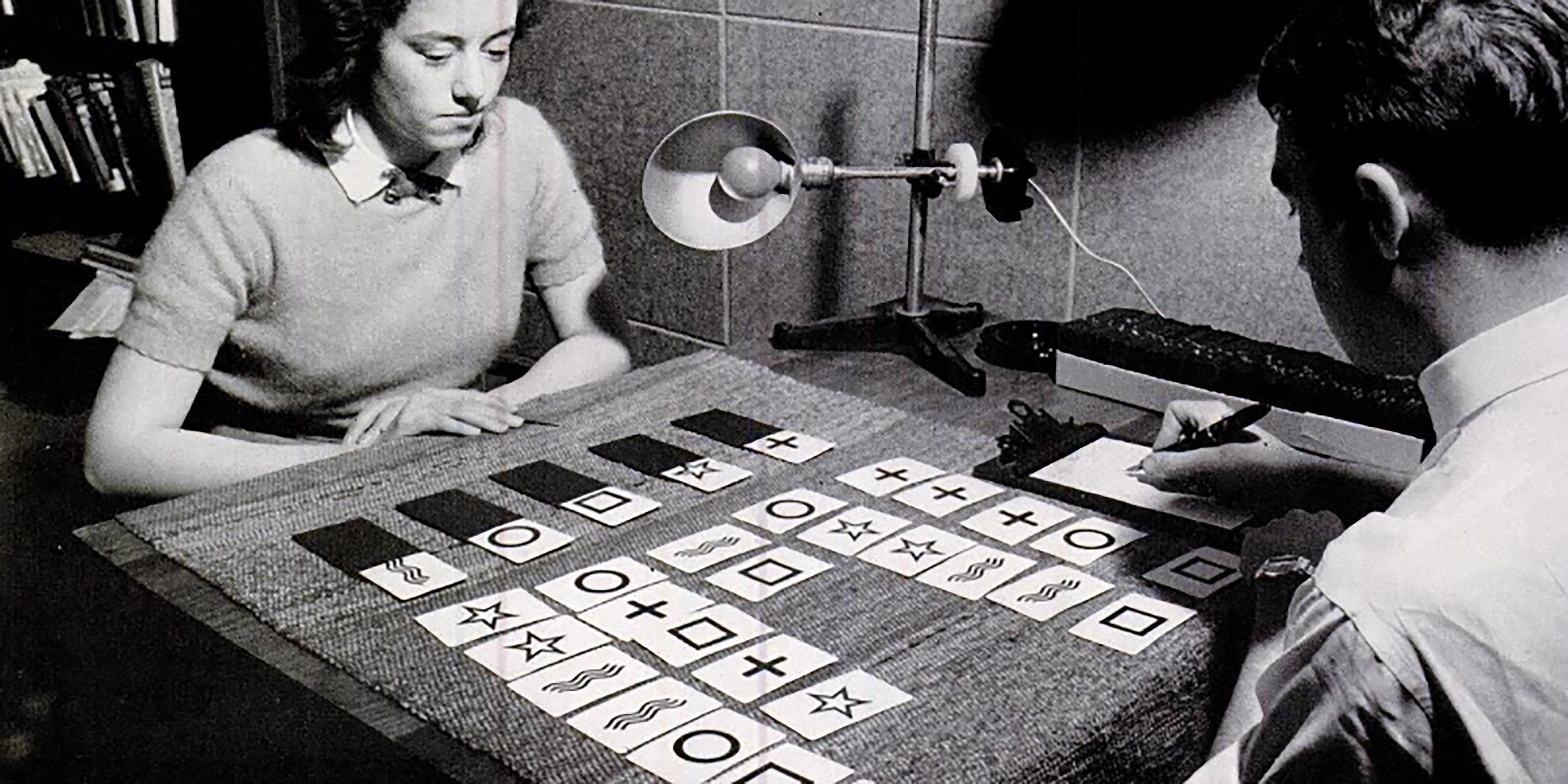 Image of a woman examining Zener cards while a man takes notes