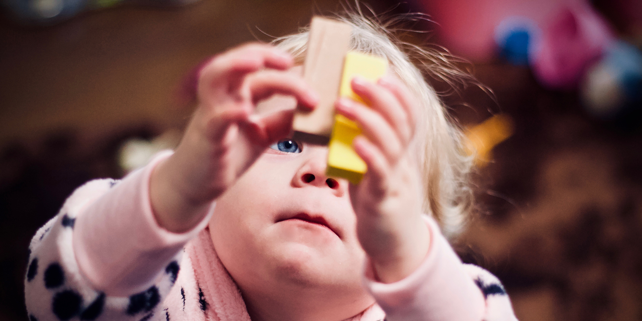 Image of infant playing with wooden blocks