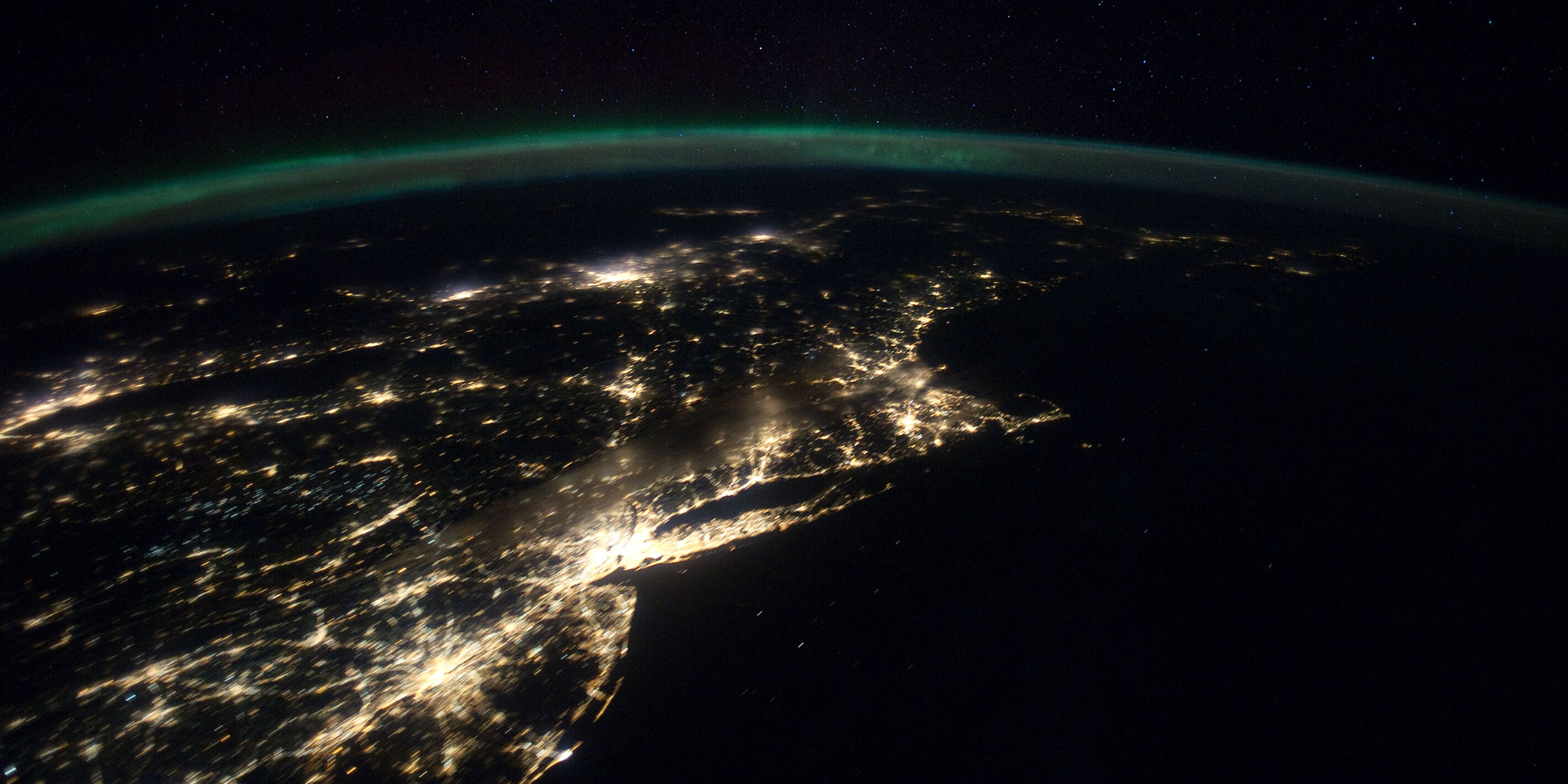 Image of bright city lights seen from Earth orbit