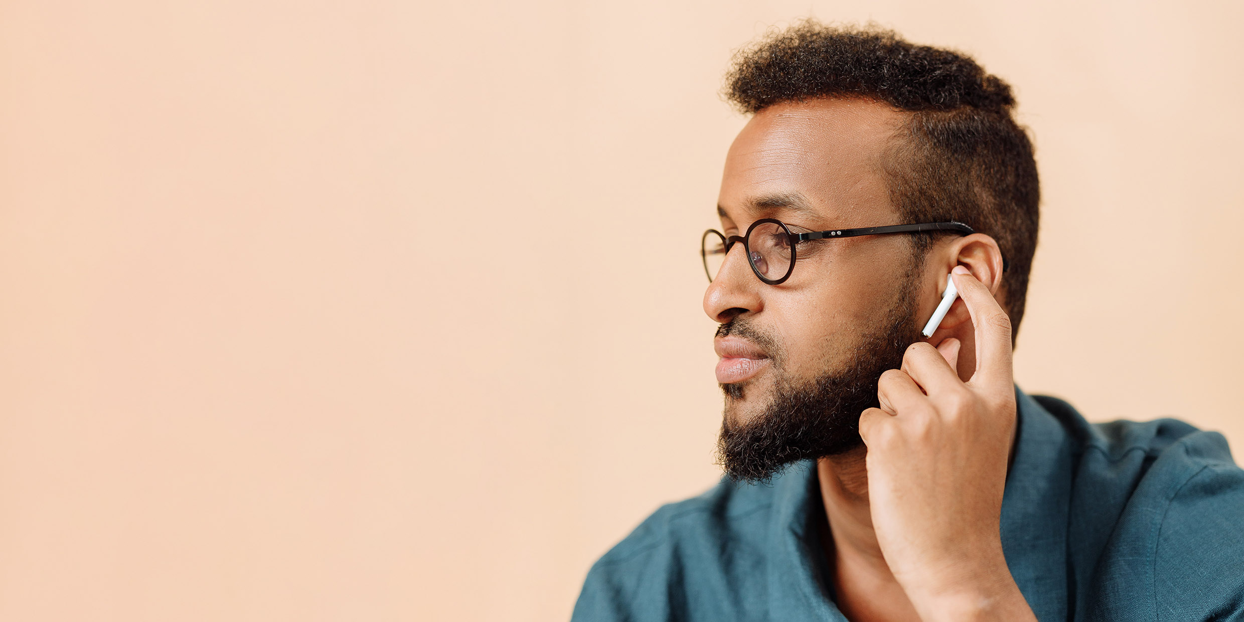 Image of a man with a bluetooth earbud in their ear