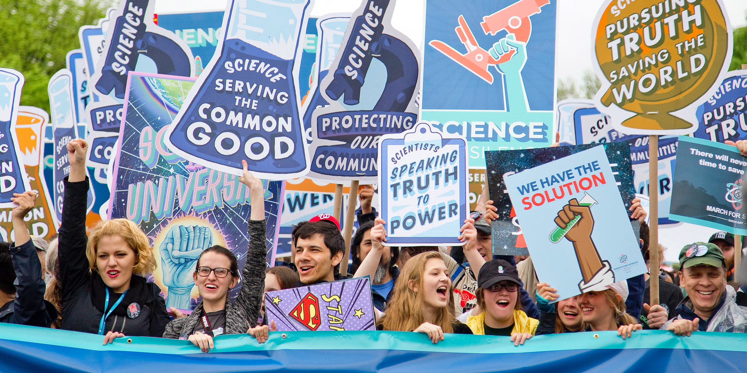 Image of demonstrators holding signs in support of science