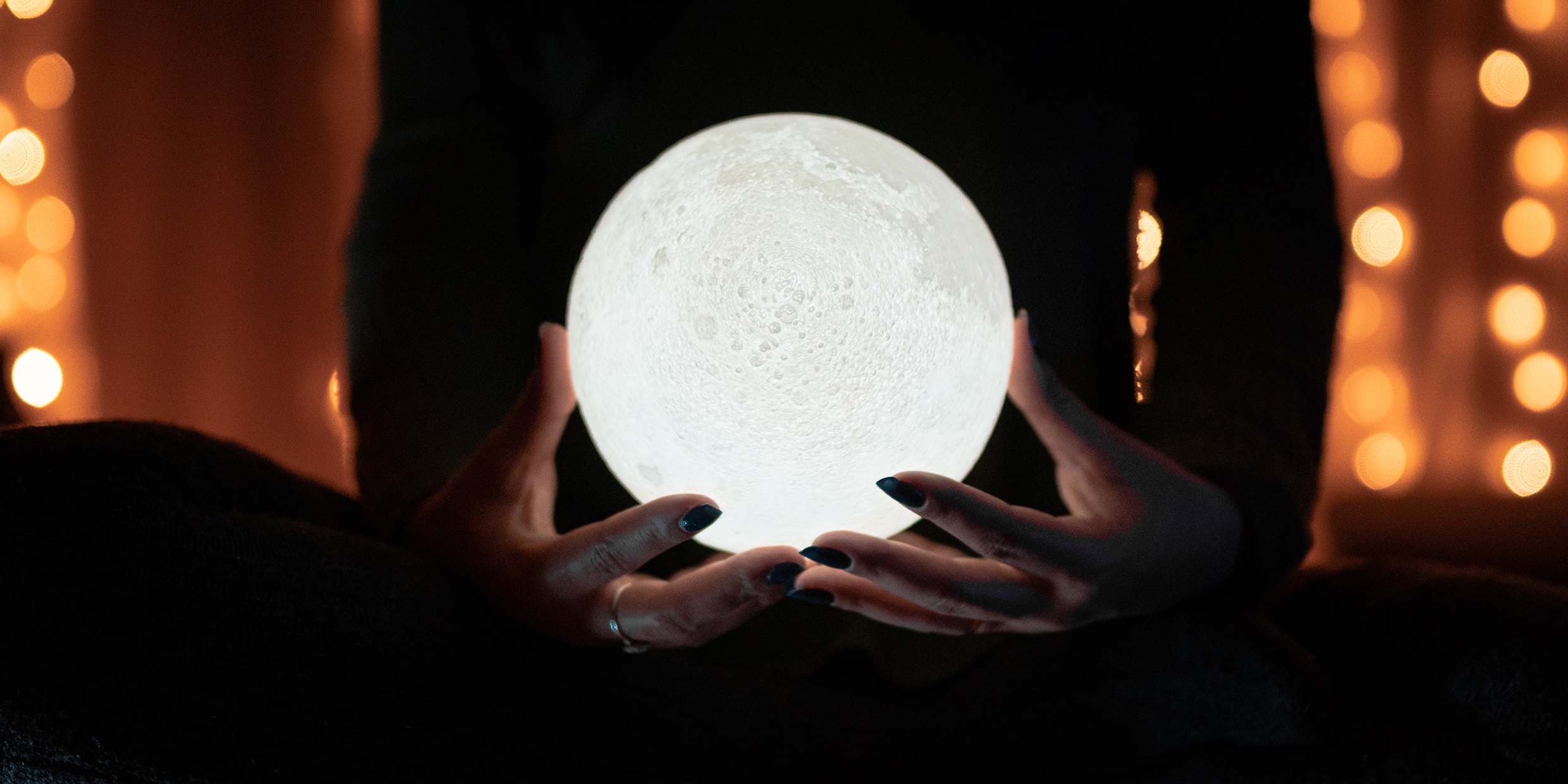 Image of a glowing orb held in a woman's hands
