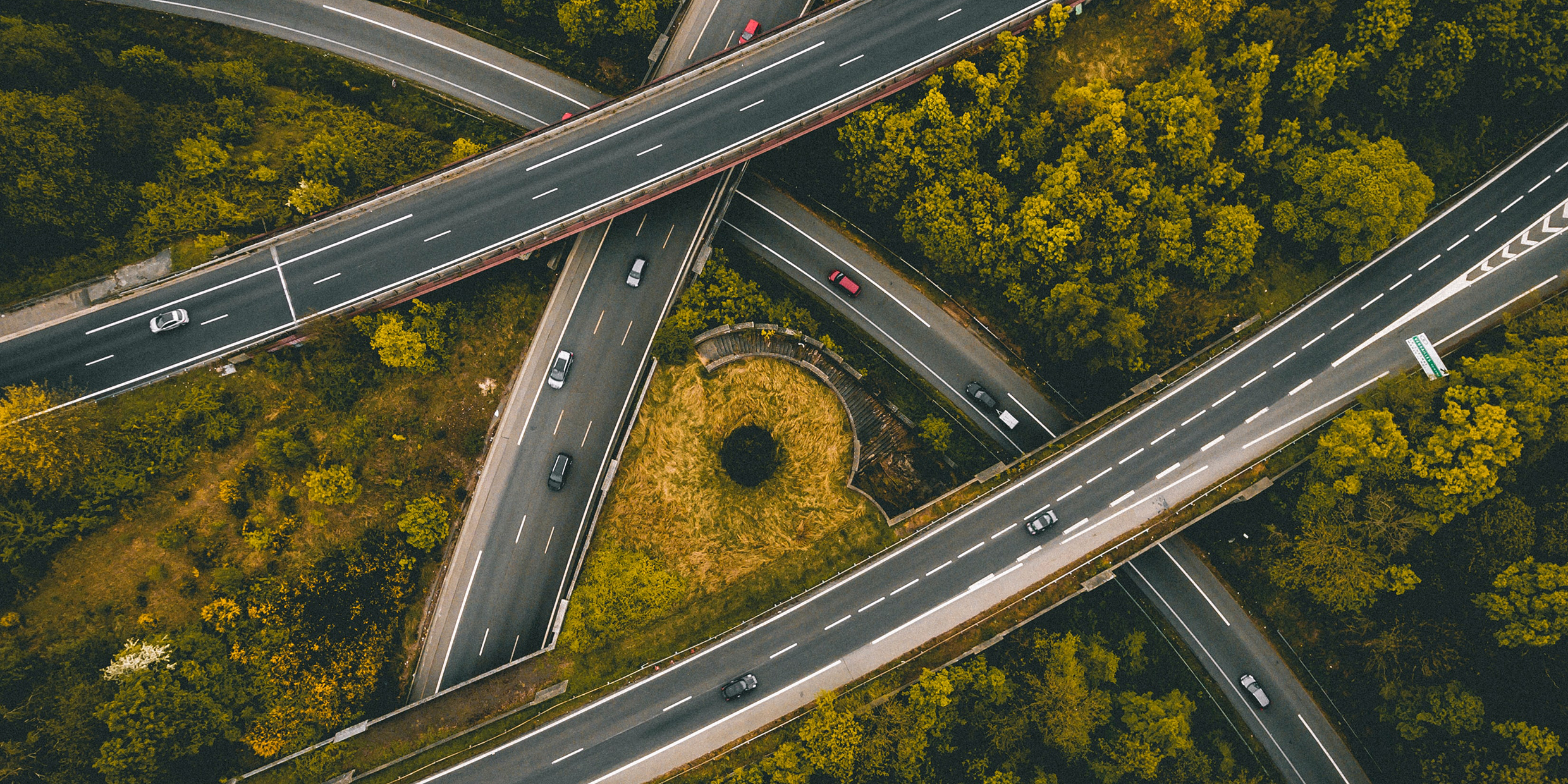 Overhead view of criss-crossing highways in a green landscape