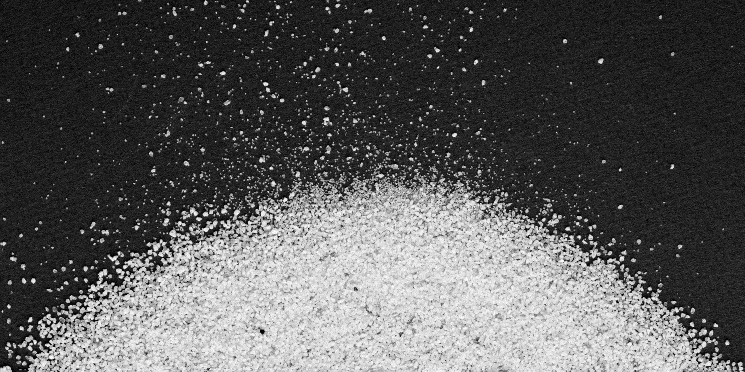 Image of pile of sugar crystals on a black background