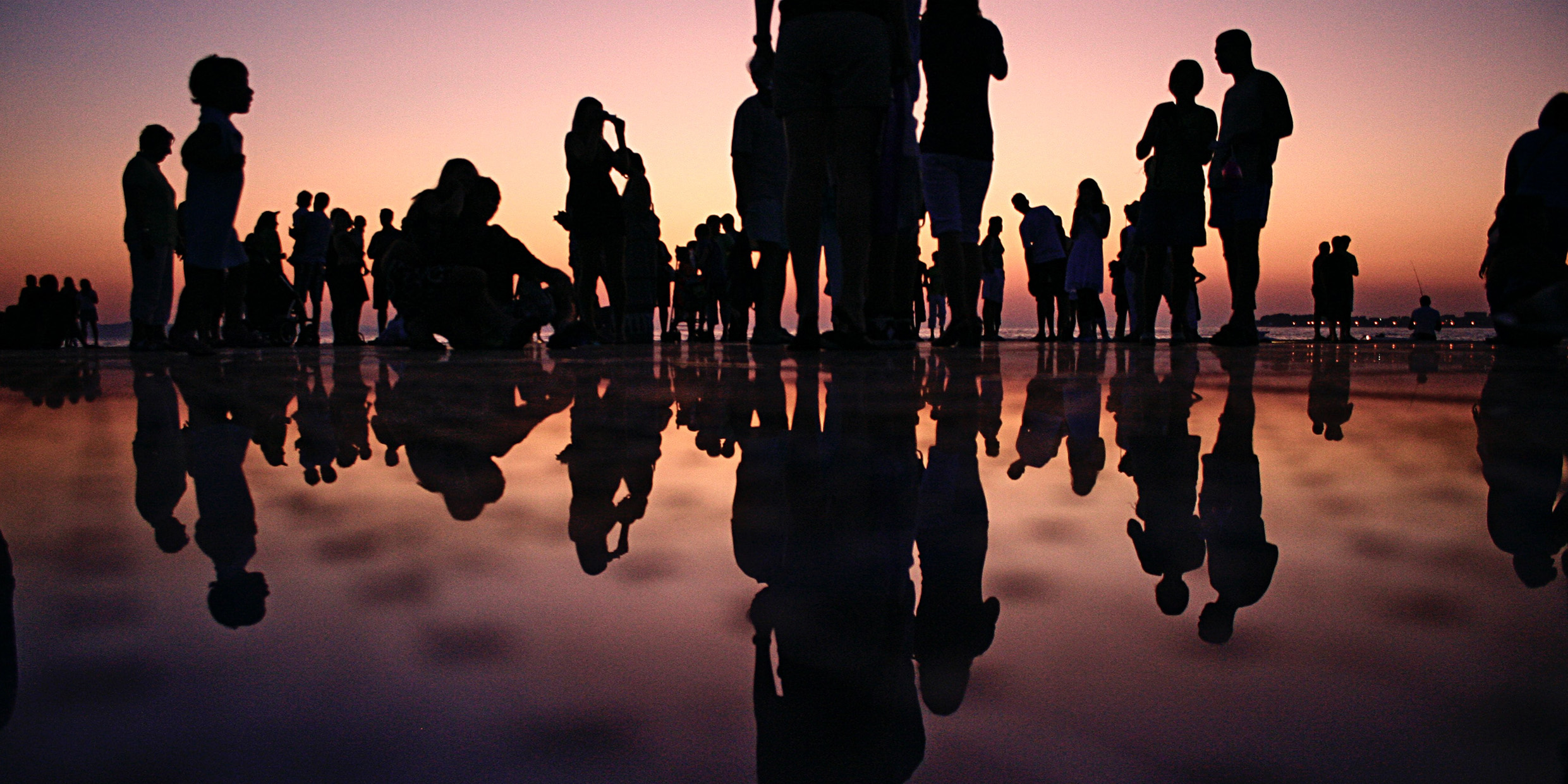Image of a group of people silhouetted at dusk