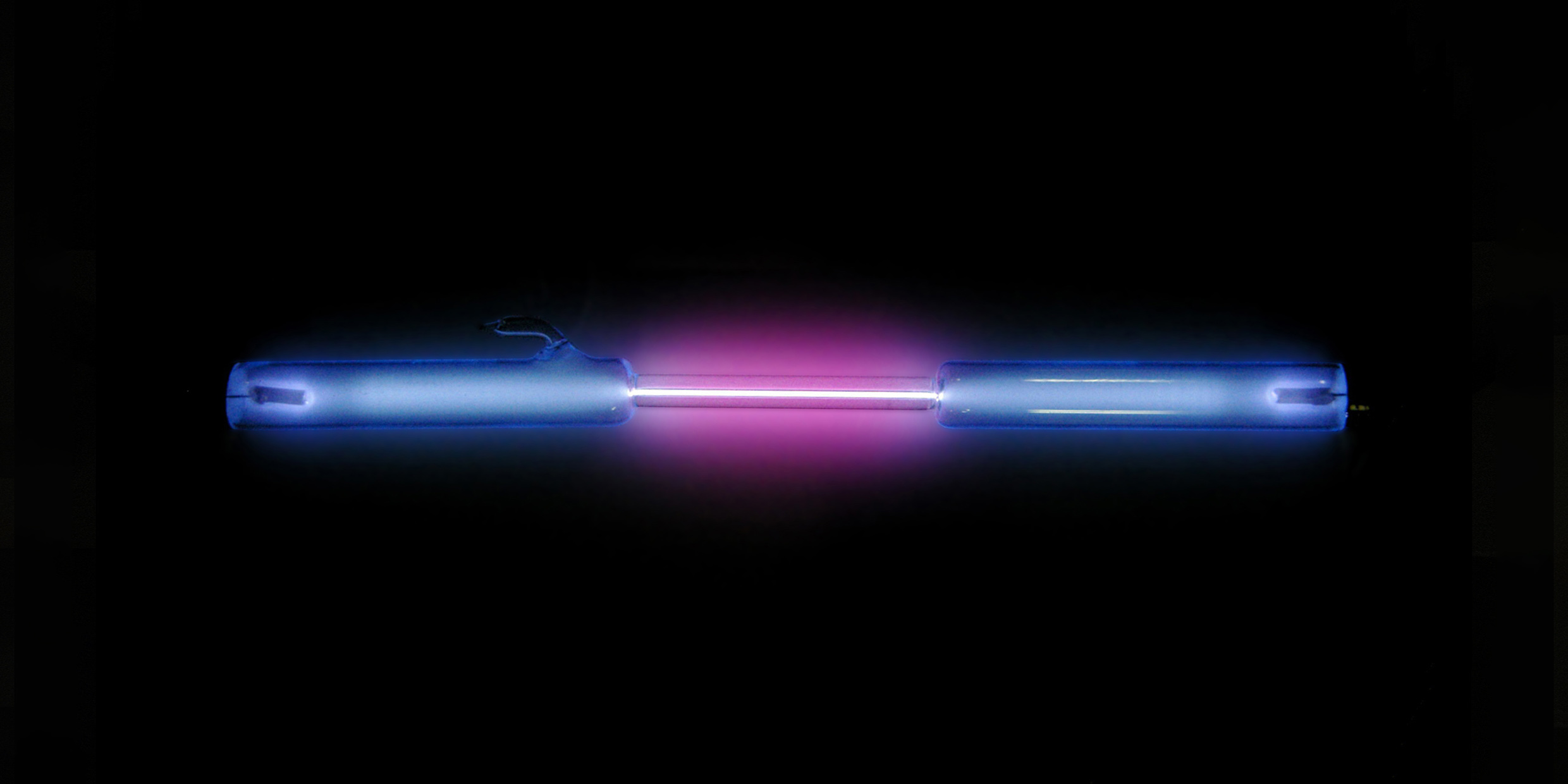 Image of a glass tube with glowing gas within