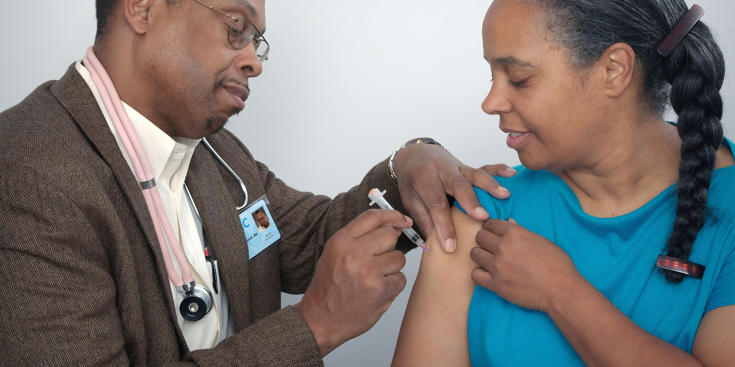 Image of a doctor administering an injection to a patient