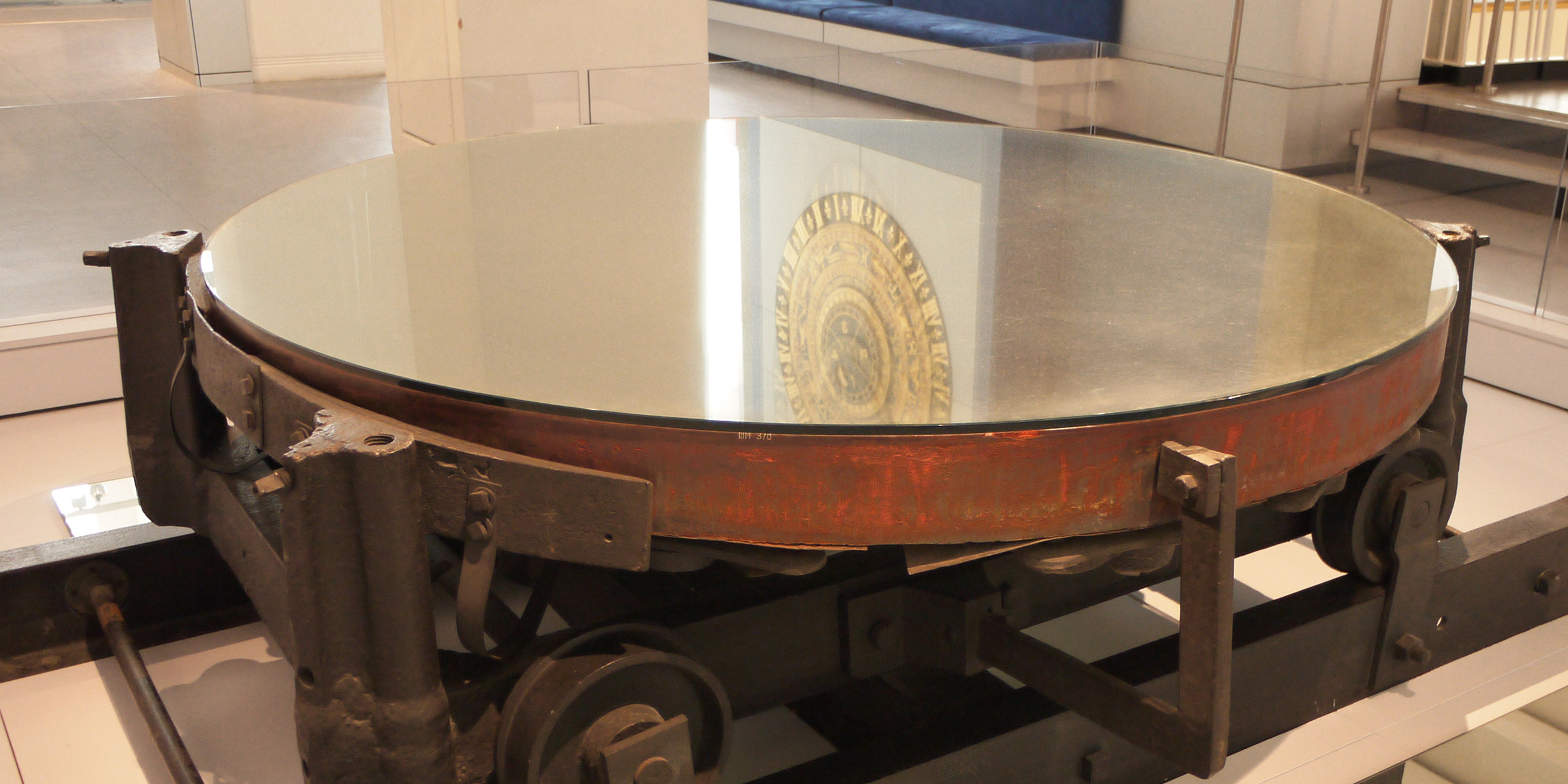Image of a large telescopic mirror displayed in a museum