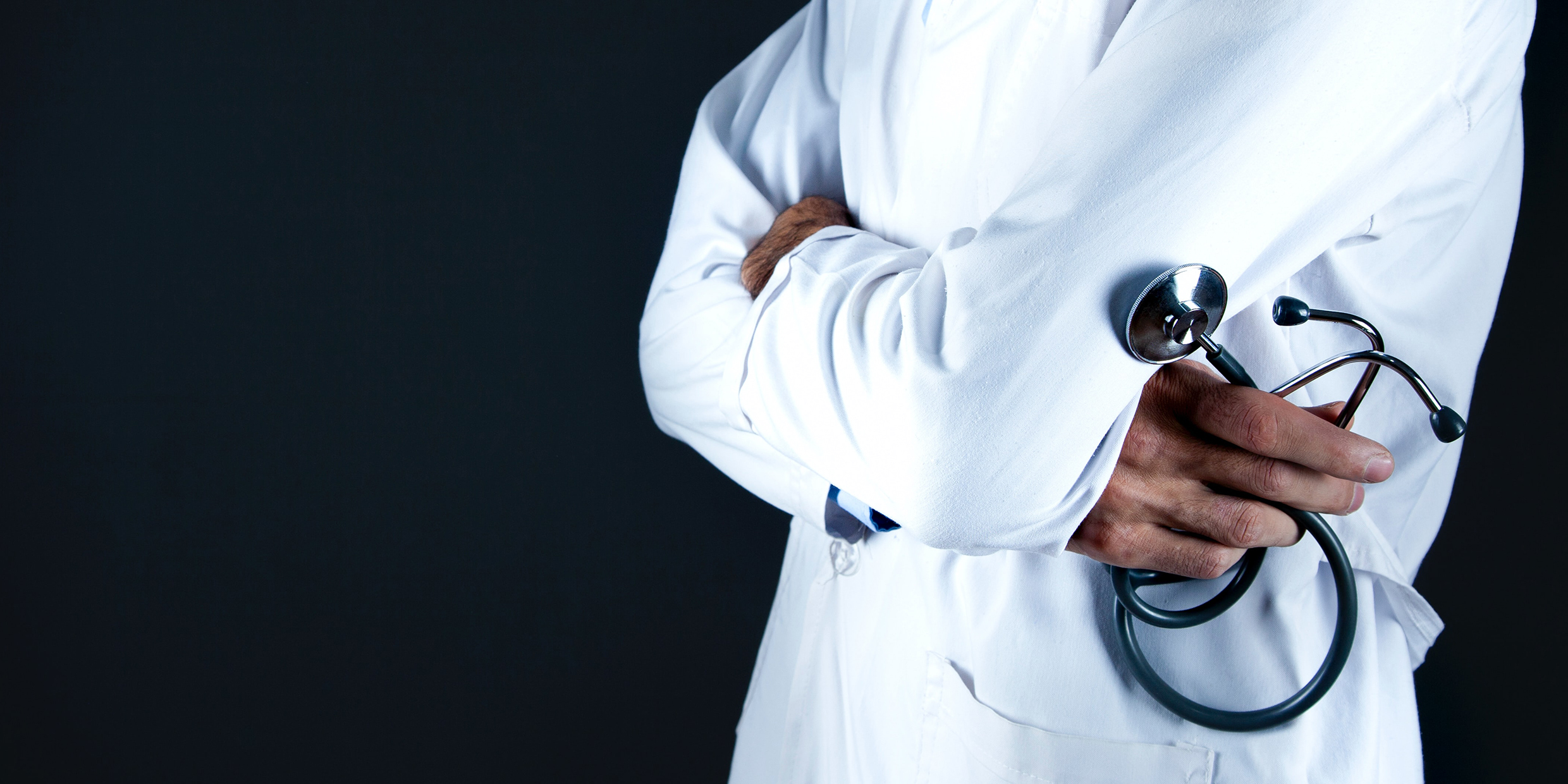 Image of a man in a white coat holding a stethoscope