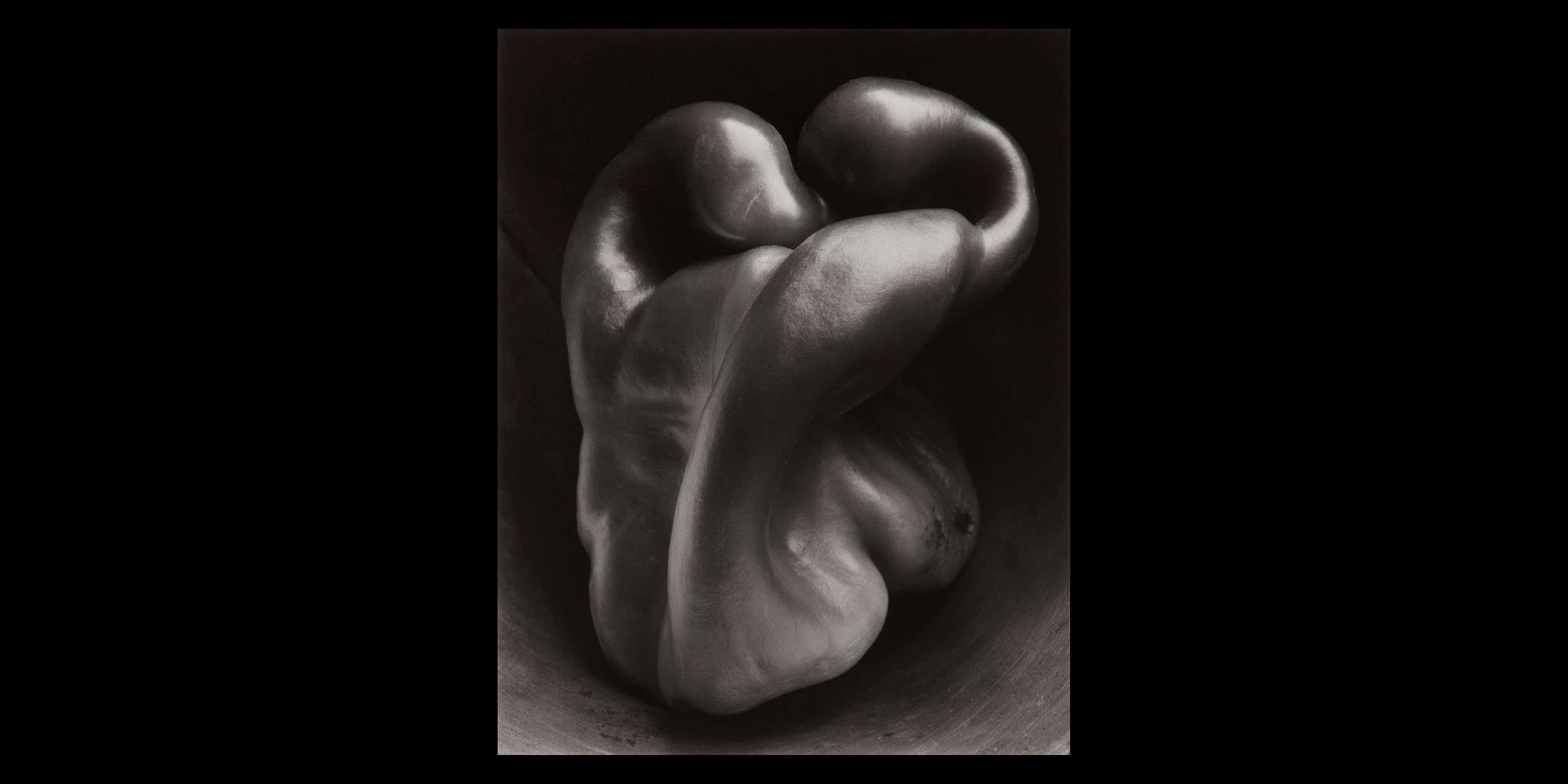 Close-up black-and-white photograph of the twisted surface of a pepper