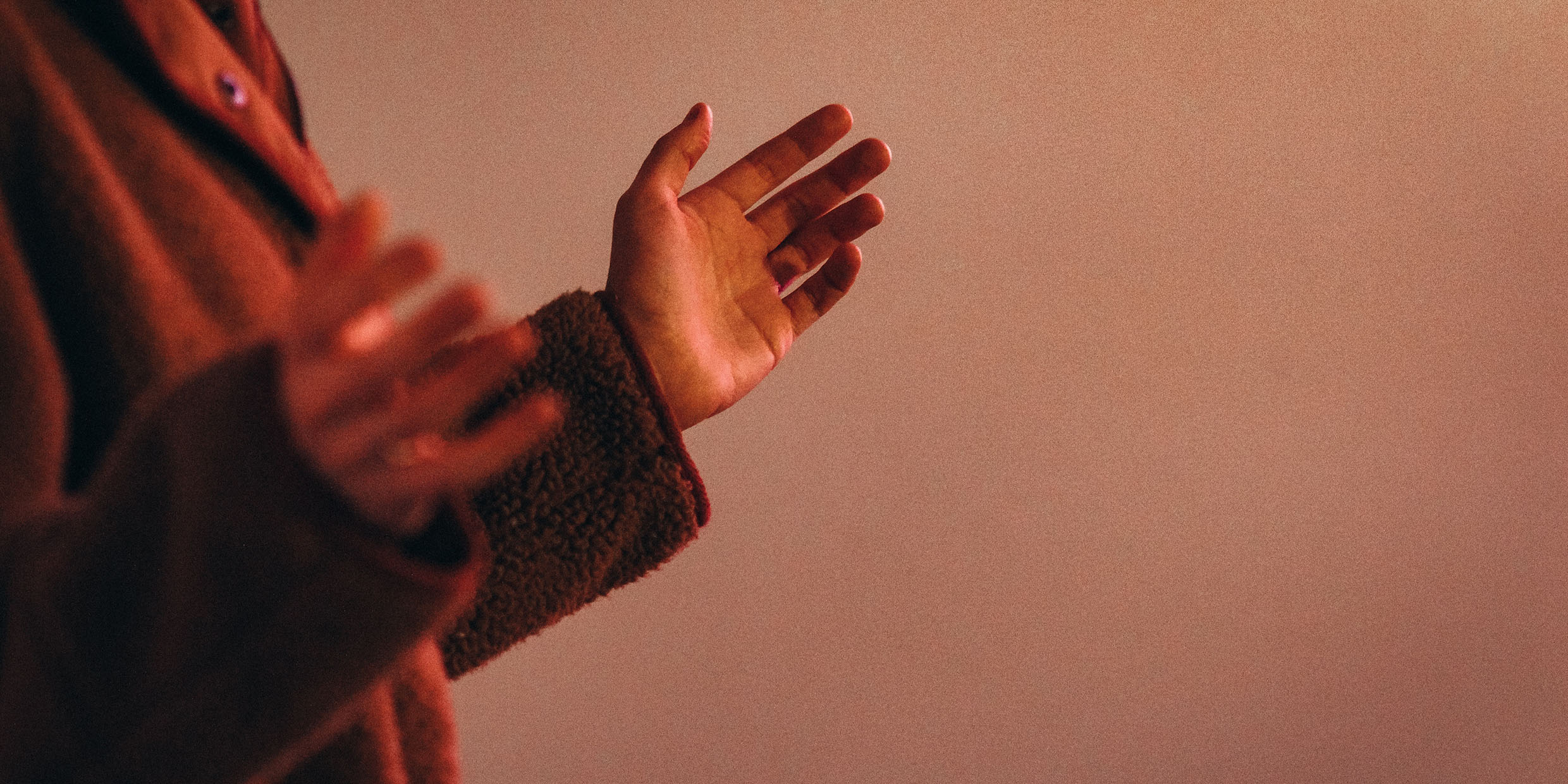 Image of a person with the hands raised in prayer