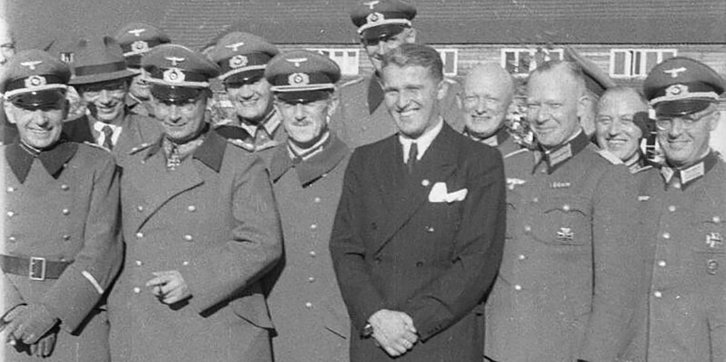 Group historical photo of a smiling Wernher von Braun together with other uniformed Nazis.
