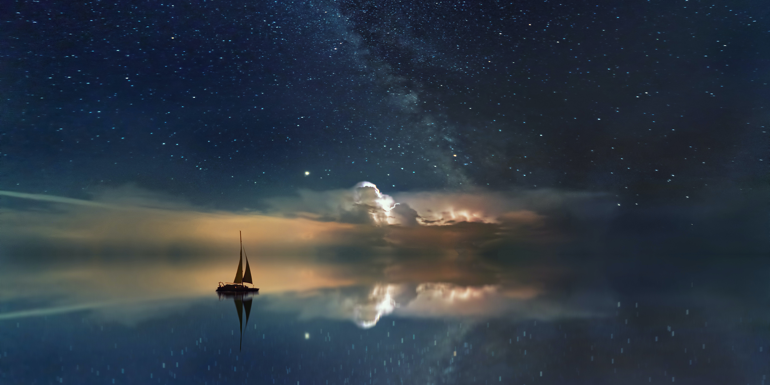 Image of a sailboat on a mirror-like sea which is reflecting the night sky