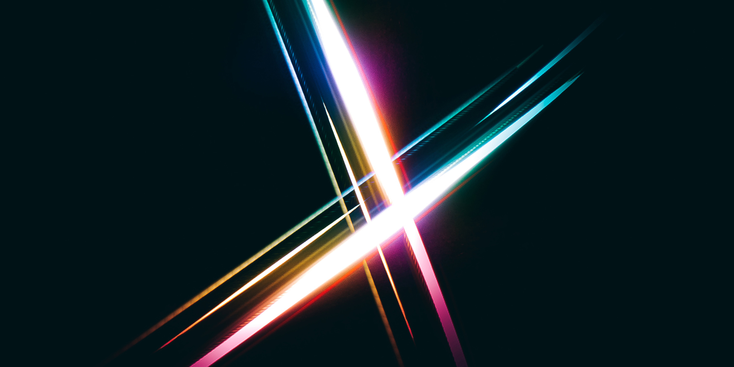 Image of glowing light patterns forming an X over a dark background