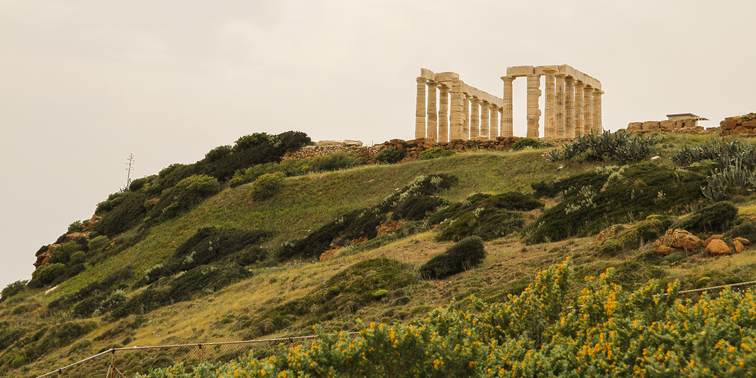 Image of a ruined classical greek building atop a hill